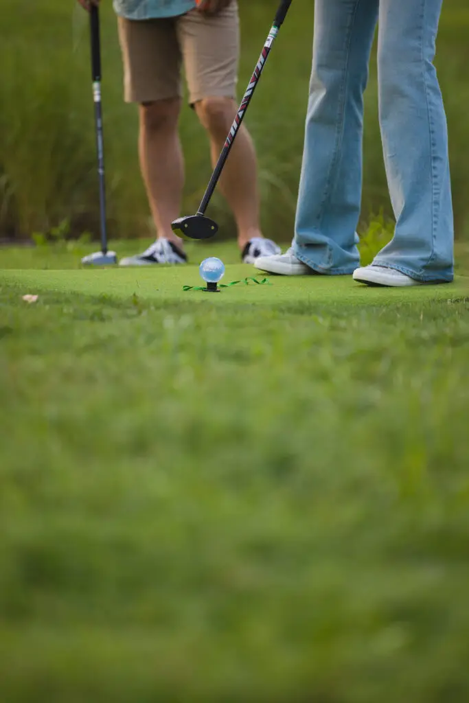 Close-up image of 2 people playing park golf at 1Club.