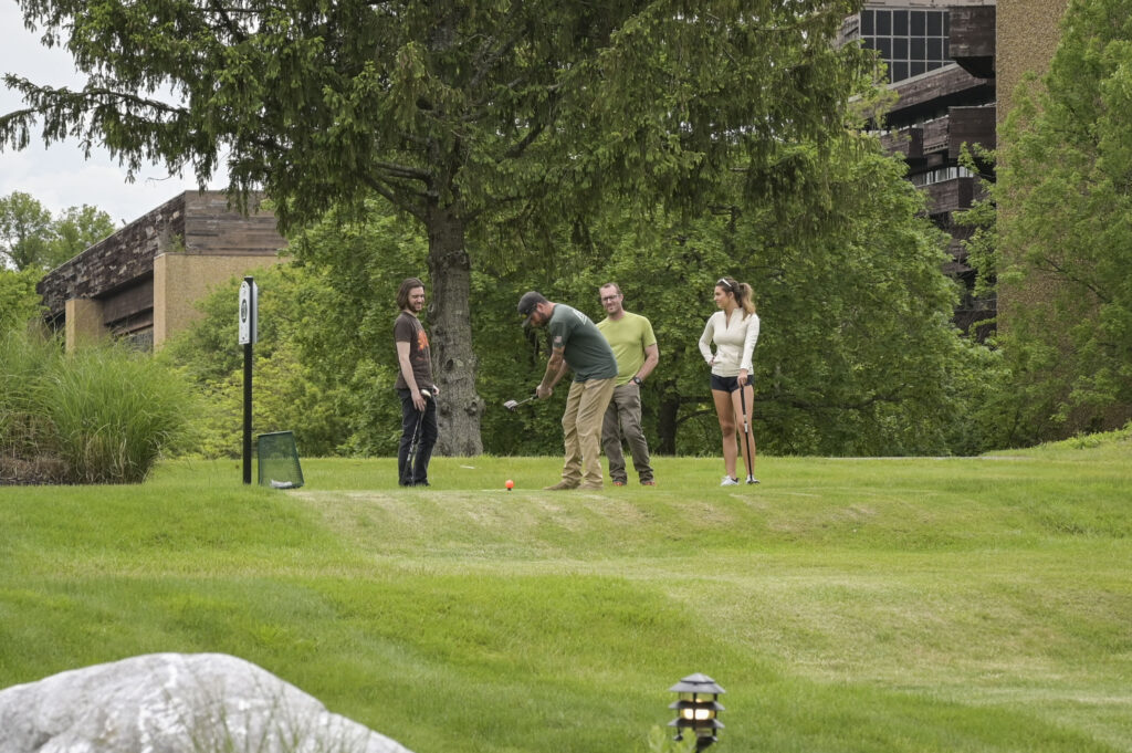 Group of people playing park golf and having fun at 1Club in Vernon, New Jersey. Unique things to do in NJ during the weekend.