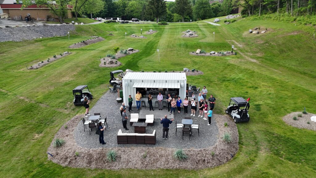 Top-down view of people gathered at the container bar at 1Club in Vernon, New Jersey.