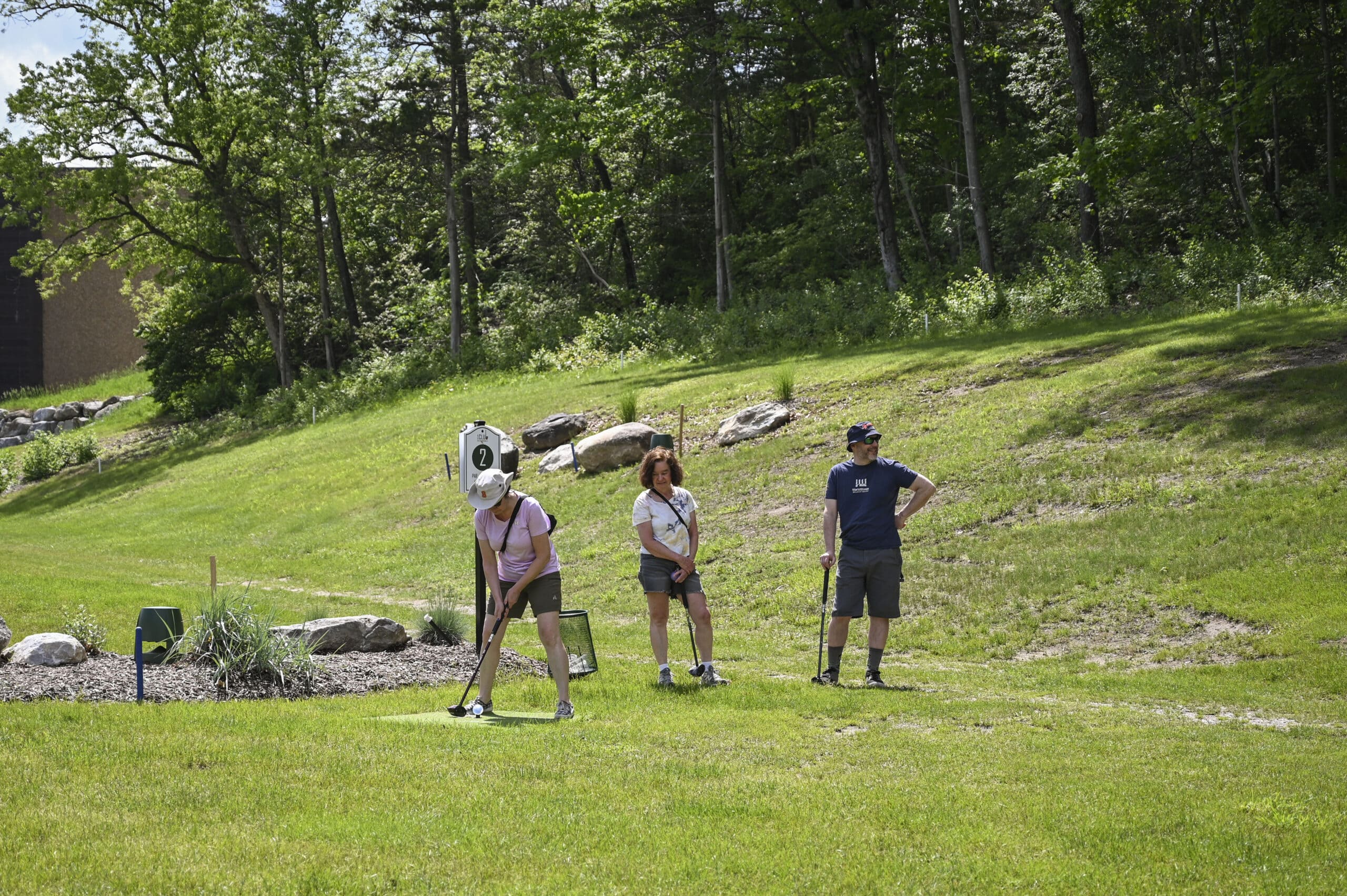 Three people playing park golf at 1Club in Vernon, NJ, enjoying a fun and relaxed game.